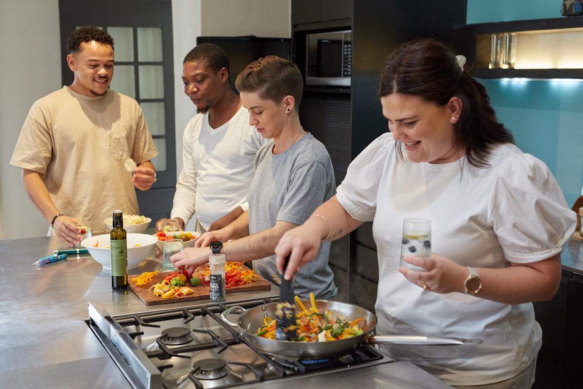 Hands preparing fresh vegetables in a bright kitchen